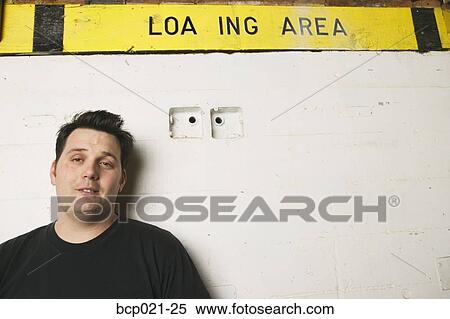 Stock Photography - A sleepy man posing on the loading dock. Fotosearch