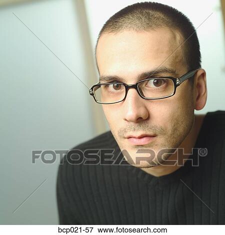 Stock Photo - A young man wearing glasses. Fotosearch
