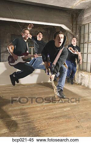 Four men in a band rock out View Large Photo Image Stock Photography - Four men in a band rock out. Fotosearch