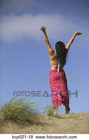 Woman with outstretched arms on a beach View Large Photo Image Stock Photo - Woman with outstretched arms on a beach. Fotosearch