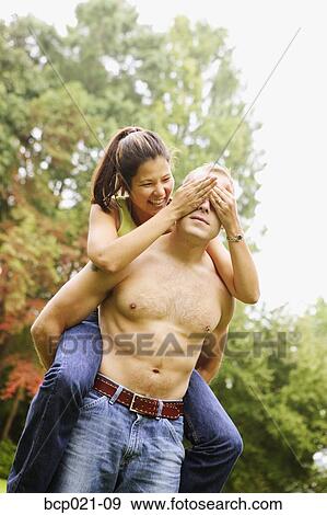 Young man giving girlfriend a piggyback ride View Large Photo Image Stock Photo - Young man giving girlfriend a piggyback ride. Fotosearch