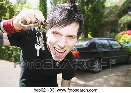 Young man with car keys in hand View Large Photo Image Stock Image - Young man with car keys in hand. Fotosearch