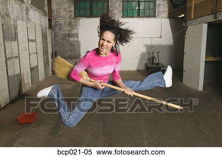 Young woman playing the air guitar View Large Photo Image Stock Photography - Young woman playing the air guitar. Fotosearch