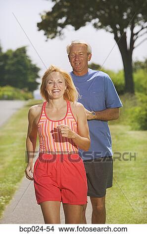 Picture - A middle-aged couple jogging. Fotosearch