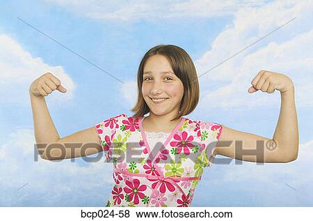 A teenaged girl flexing her muscles View Large Photo Image Stock Photo - A teenaged girl flexing her muscles. Fotosearch