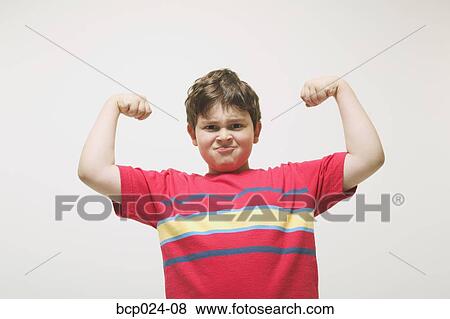 A young boy flexing his muscles View Large Photo Image Stock Photo - A young boy flexing his muscles. Fotosearch