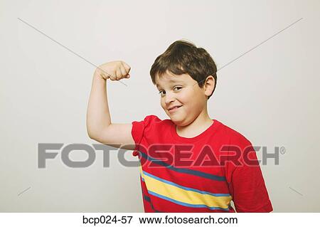 A young boy flexing his muscles View Large Photo Image Stock Photo - A young boy flexing his muscles. Fotosearch