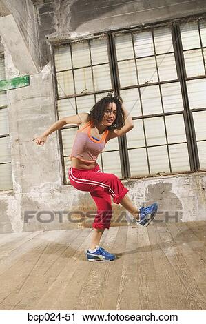 A young woman exercising View Large Photo Image Stock Image - A young woman exercising. Fotosearch