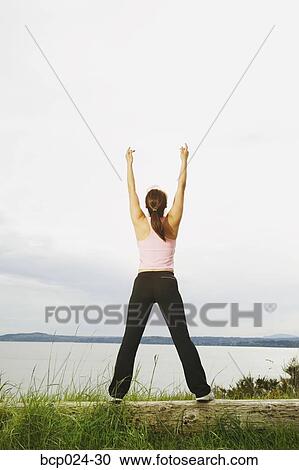 A young woman stretching View Large Photo Image Stock Image - A young woman stretching. Fotosearch