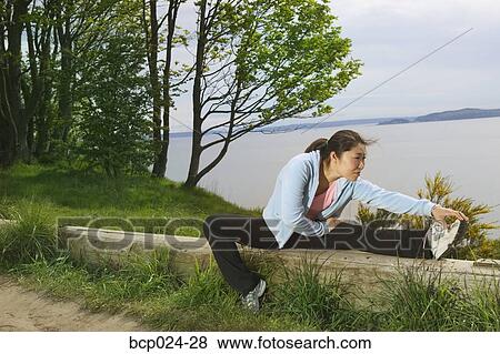 Stock Photo - A young woman stretching. Fotosearch