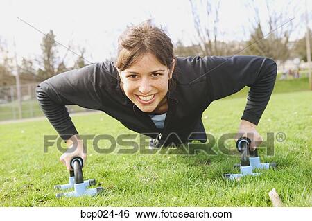 Stock Photograph - A young woman working out. Fotosearch