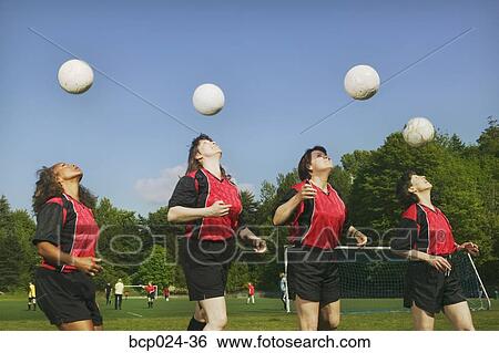 Four young female soccer players heading balls View Large Photo Image Stock Photograph - Four young female soccer players heading balls. Fotosearch