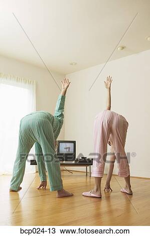 Middle-aged couple exercising to a TV program View Large Photo Image Stock Image - Middle-aged couple exercising to a TV program. Fotosearch