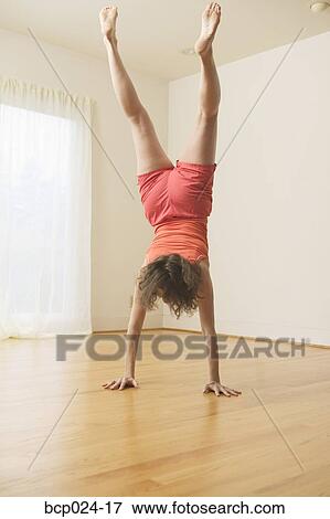 Middle-aged woman doing handstand View Large Photo Image Stock Photo - Middle-aged woman doing handstand. Fotosearch