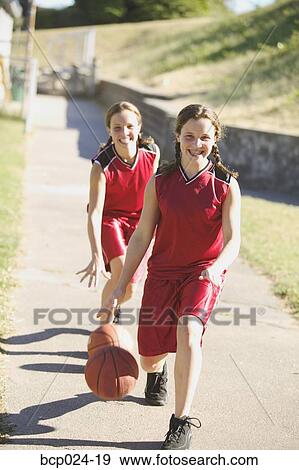 Teen girls dribbling basketballs View Large Photo Image Stock Photo - Teen girls dribbling basketballs. Fotosearch