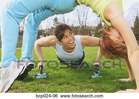 Stock Photograph - Two young women working out together. Fotosearch