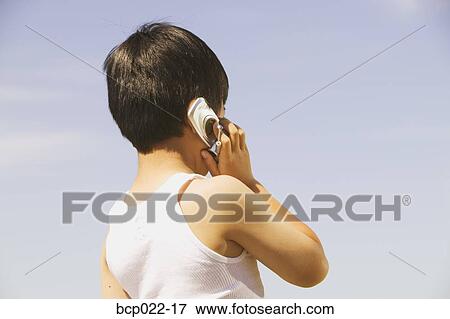A boy using a mobile phone View Large Photo Image Stock Photo - A boy using a mobile phone. Fotosearch