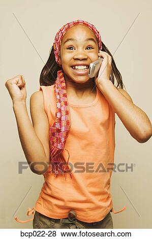 A girl talking on a mobile phone View Large Photo Image Stock Photo - A girl talking on a mobile phone. Fotosearch