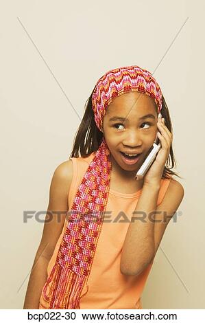 Stock Image - A girl talking on her mobile phone. Fotosearch