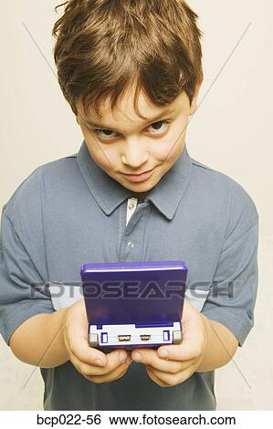 A little boy playing a computerized game View Large Photo Image Stock Photograph - A little boy playing a computerized game. Fotosearch