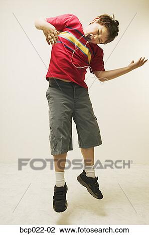 A young boy playing the air guitar View Large Photo Image Stock Image - A young boy playing the air guitar. Fotosearch