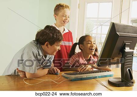 Three children using a home computer View Large Photo Image Picture - Three children using a home computer. Fotosearch