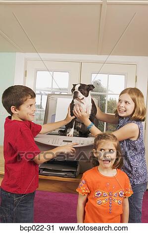 Three kids faxing a dog View Large Photo Image Stock Image - Three kids faxing a dog. Fotosearch