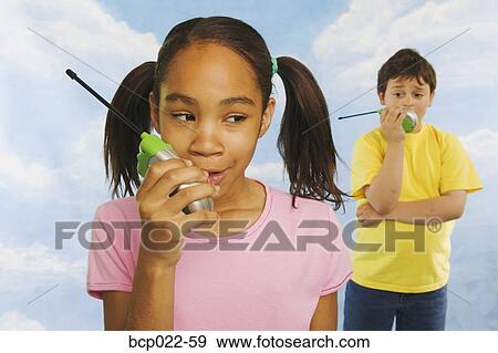 Two kids talking on walkie-talkies View Large Photo Image Stock Photo - Two kids talking on walkie-talkies. Fotosearch