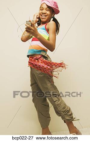 Young girl listening to music View Large Photo Image Stock Photo - Young girl listening to music. Fotosearch