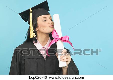 A female graduate kissing her diploma View Large Photo Image Stock Image - A female graduate kissing her diploma. Fotosearch