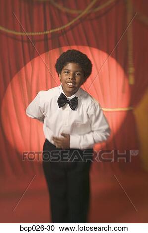 Boy on stage taking a bow View Large Photo Image Stock Image - Boy on stage taking a bow. Fotosearch