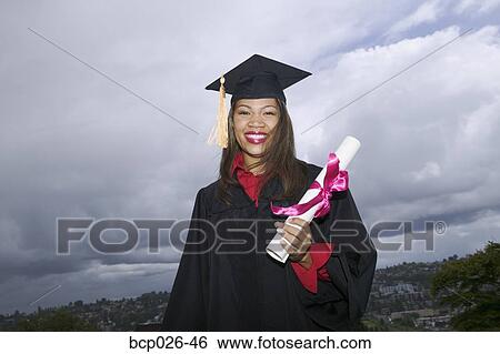 Female graduate holding her diploma View Large Photo Image Stock Photograph - Female graduate holding her diploma. Fotosearch