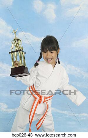 Girl in karate uniform with trophy View Large Photo Image Stock Image - Girl in karate uniform with trophy. Fotosearch