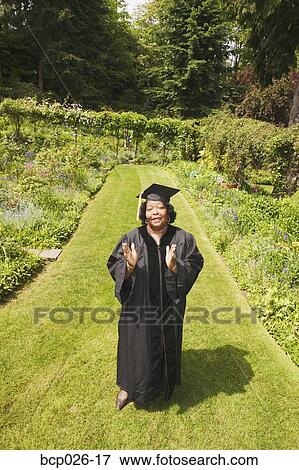 Graduation day for woman in cap and gown View Large Photo Image Stock Photo - Graduation day for woman in cap and gown. Fotosearch