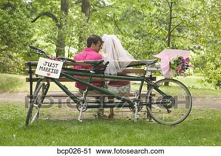 Newlyweds relax after a bicycle ride View Large Photo Image Stock Image - Newlyweds relax after a bicycle ride. Fotosearch
