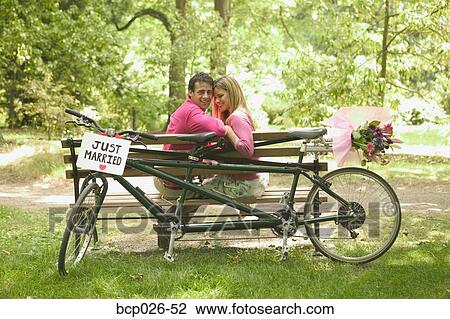 Newlyweds relax after a bicycle ride View Large Photo Image Stock Image - Newlyweds relax after a bicycle ride. Fotosearch