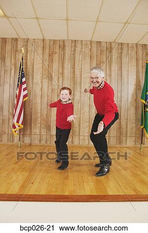 Young boy and man dancing on stage View Large Photo Image Stock Image - Young boy and man dancing on stage. Fotosearch