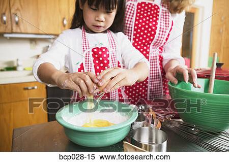 A female adult and child cooking together View Large Photo Image Stock Photography - A female adult and child cooking together. Fotosearch