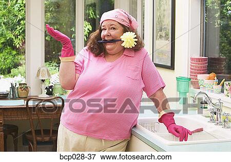 A woman about to do the dishes View Large Photo Image Stock Photo - A woman about to do the dishes. Fotosearch
