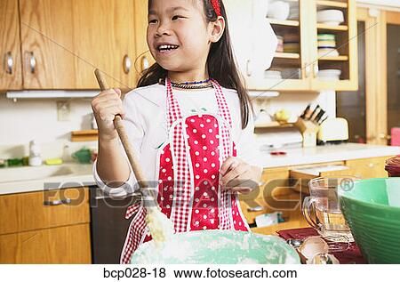 A young girl cooking View Large Photo Image Stock Photo - A young girl cooking. Fotosearch