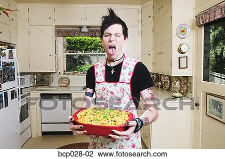 Man in the kitchen holding a casserole View Large Photo Image Stock Image - Man in the kitchen holding a casserole. Fotosearch