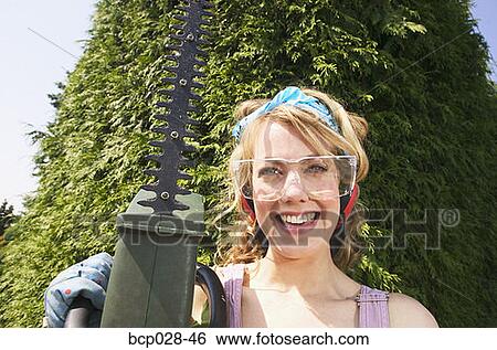 Portrait of woman with power hedge trimmer View Large Photo Image Stock Photograph - Portrait of woman with power hedge trimmer. Fotosearch