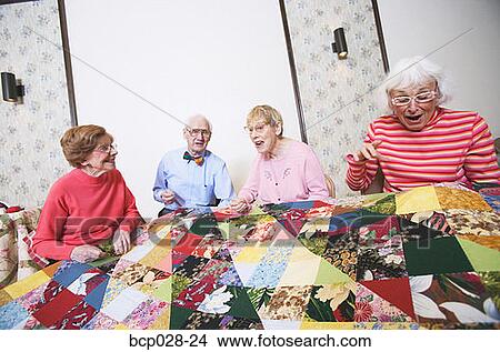 Picture - Seniors interacting at a quilting bee. Fotosearch
