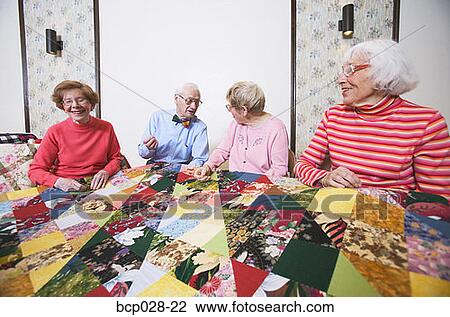 Seniors interacting at a quilting bee View Large Photo Image Stock Image - Seniors interacting at a quilting bee. Fotosearch