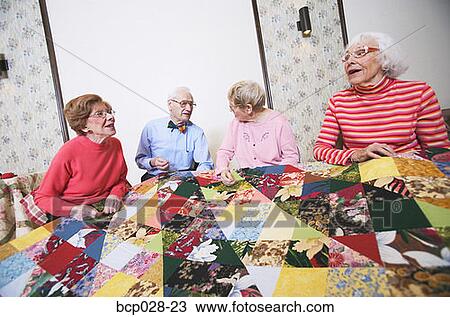 Seniors interacting at a quilting bee View Large Photo Image Stock Image - Seniors interacting at a quilting bee. Fotosearch