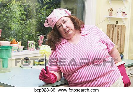 Unhappy woman about to wash dishes View Large Photo Image Stock Photograph - Unhappy woman about to wash dishes. Fotosearch
