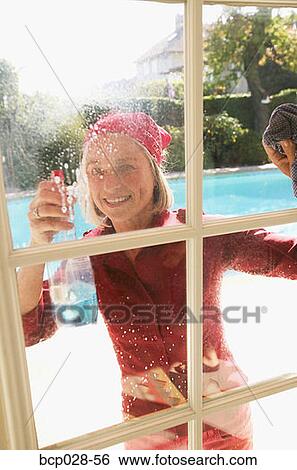 Stock Photograph - Woman cleaning windows. Fotosearch