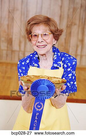 Woman holding her award winning pie View Large Photo Image Stock Photo - Woman holding her award winning pie. Fotosearch