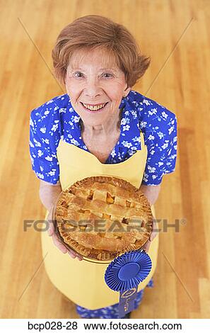Woman holding her award winning pie View Large Photo Image Stock Photo - Woman holding her award winning pie. Fotosearch