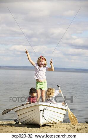Children playing in a rowboat on a beach View Large Photo Image Stock Image - Children playing in a rowboat on a beach. Fotosearch